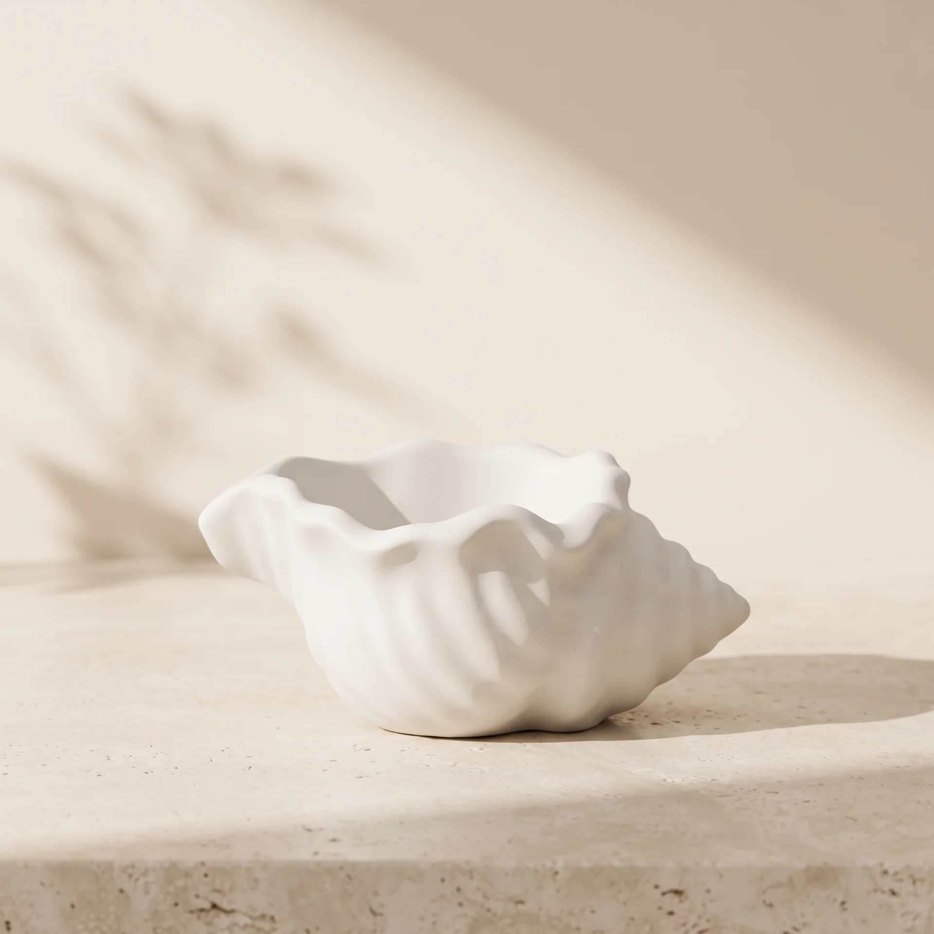 Fotografía de producto de concha marina decorativa en yeso blanco sobre superficie de piedra clara con estilo minimalista